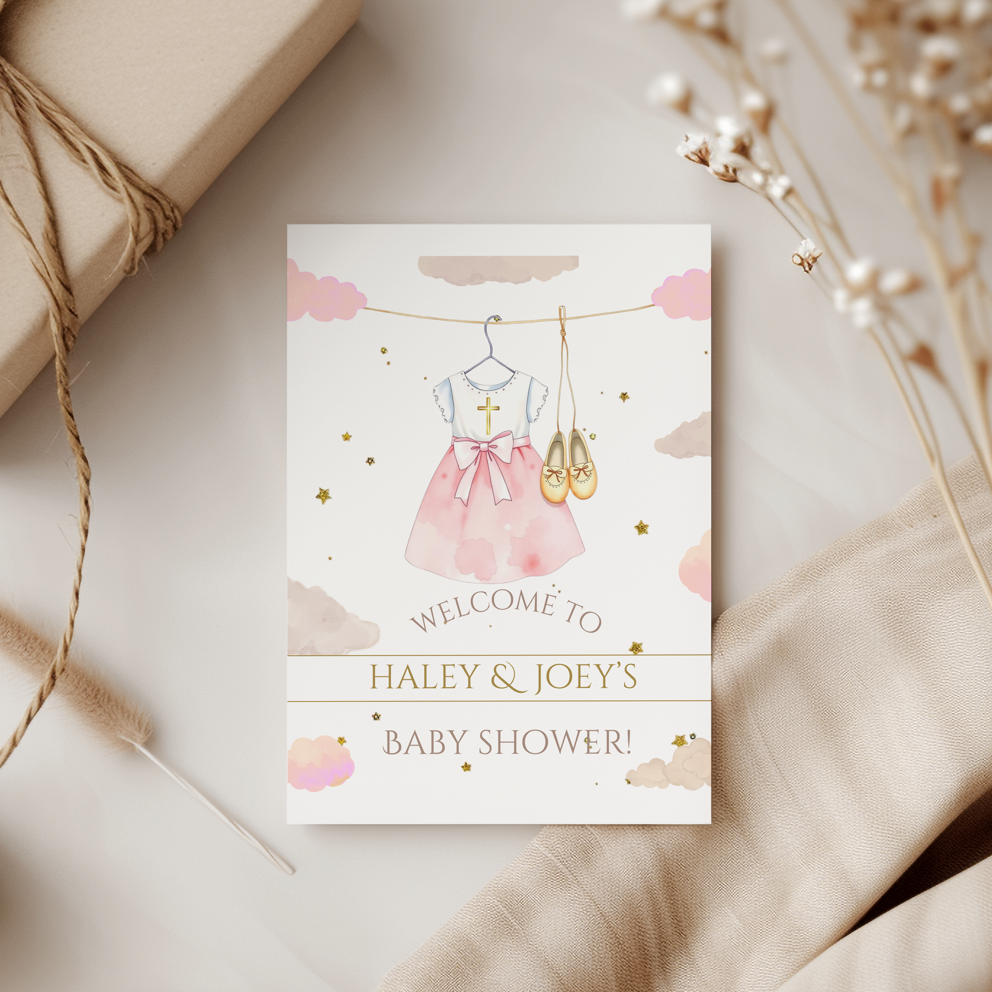 Baby shower invitation card with pink dress and ballet shoes on a neutral background