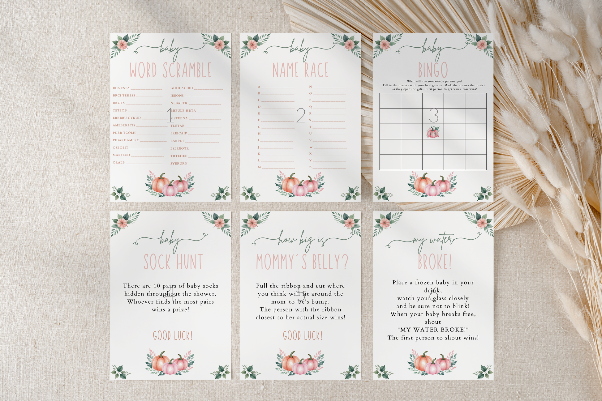 Set of baby shower games with floral designs on a textured surface.