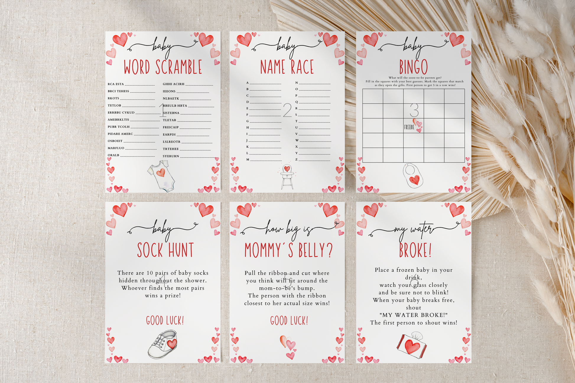 Set of baby shower games on a textured surface with decorative elements.