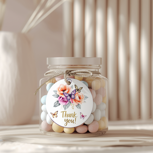 Jar of pastel candies with a decorative tag on a neutral background