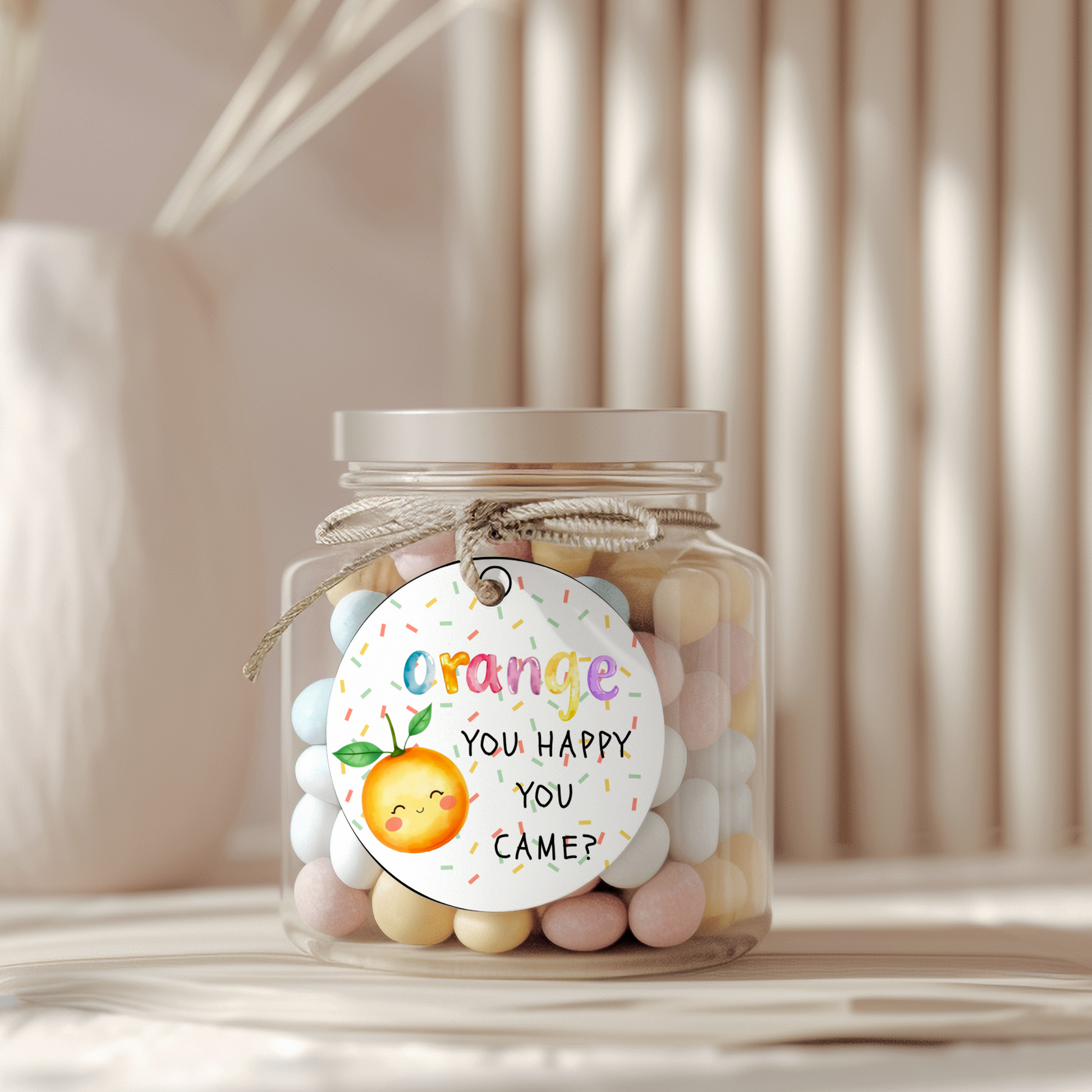 Jar of colorful candies with a decorative tag on a neutral background