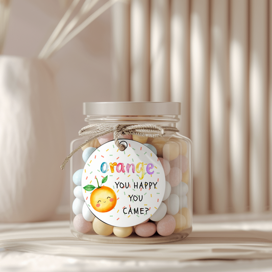 Jar of colorful candies with a decorative tag on a neutral background