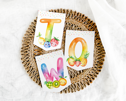 Three colorful alphabet cards with fruits on a woven tray