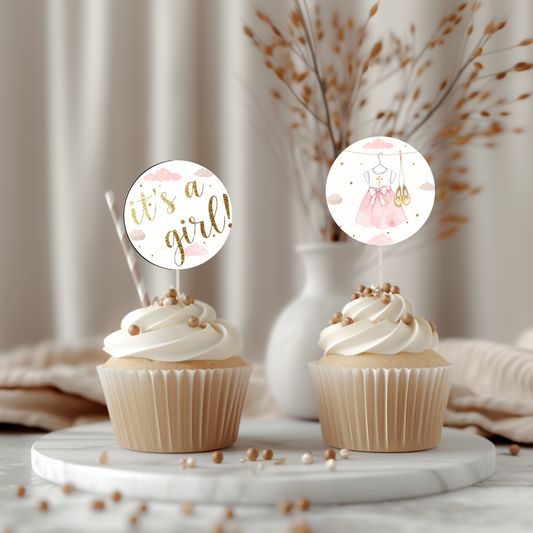 Two cupcakes with decorative toppers on a marble surface with a neutral background
