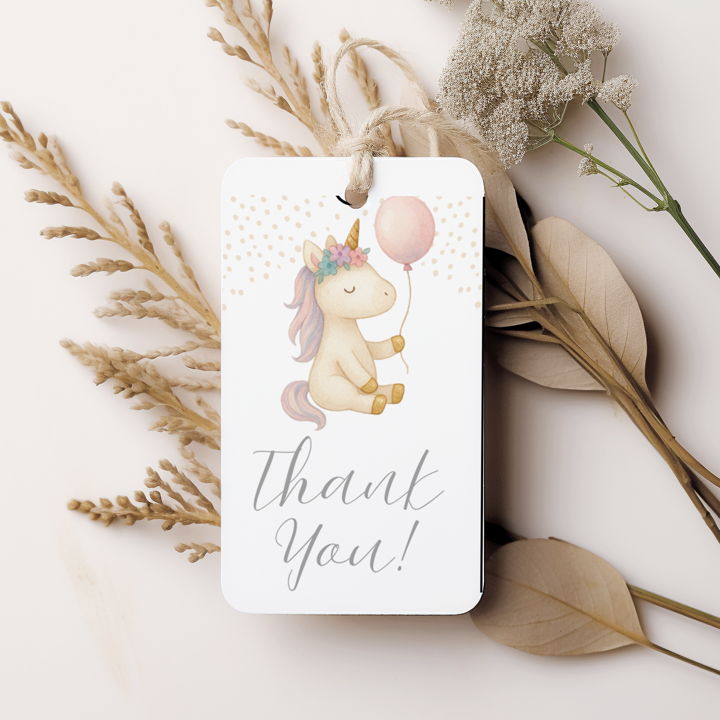 Card with a unicorn illustration and 'Thank You!' text, surrounded by dried flowers on a light background.