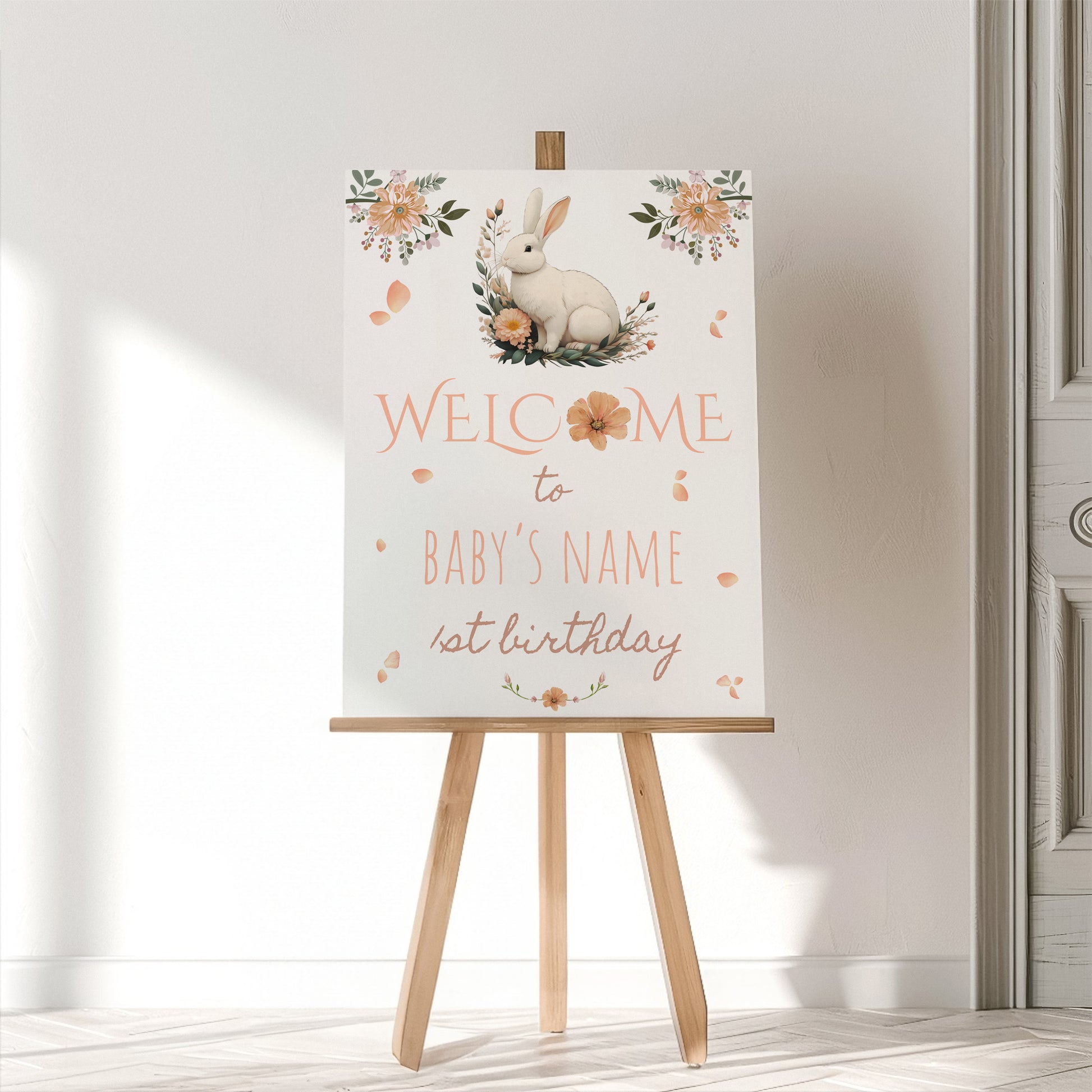 Decorative sign with a rabbit illustration on an easel against a white wall.