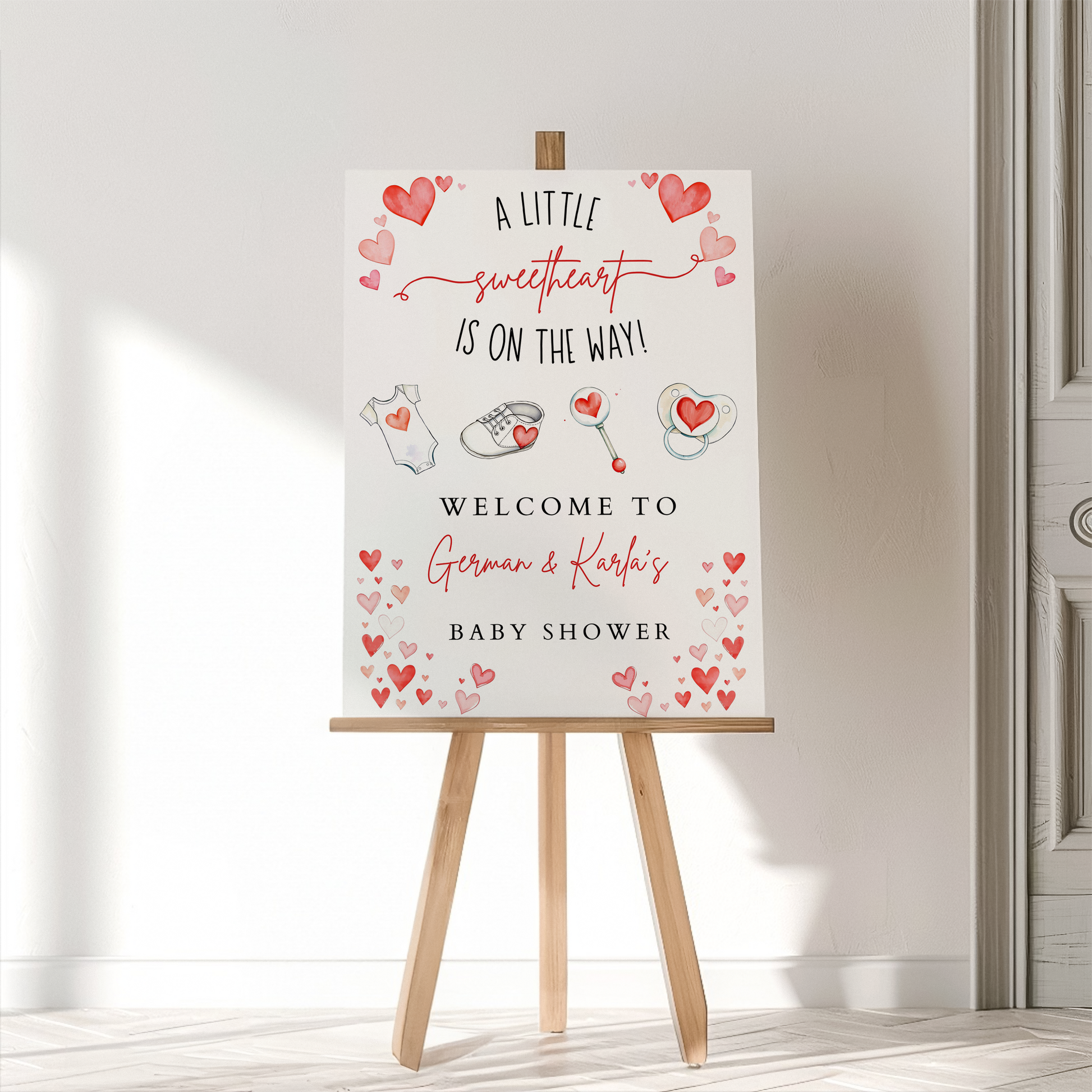 Baby shower welcome sign on an easel with decorative elements
