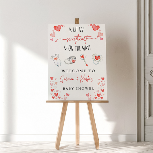Baby shower welcome sign on an easel with decorative elements