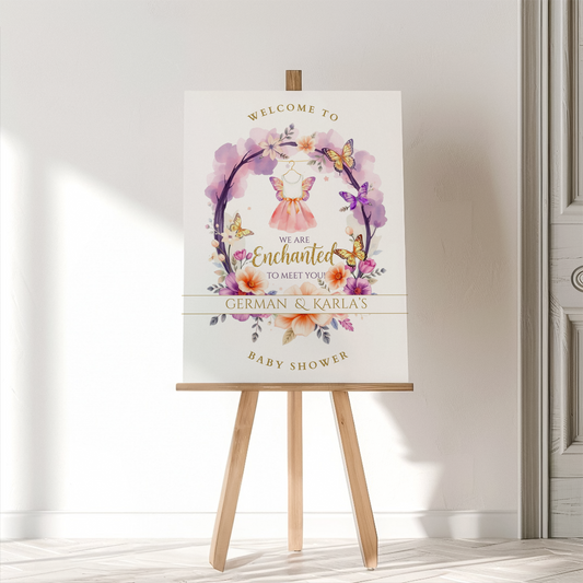 Baby shower welcome sign on an easel with floral and butterfly design