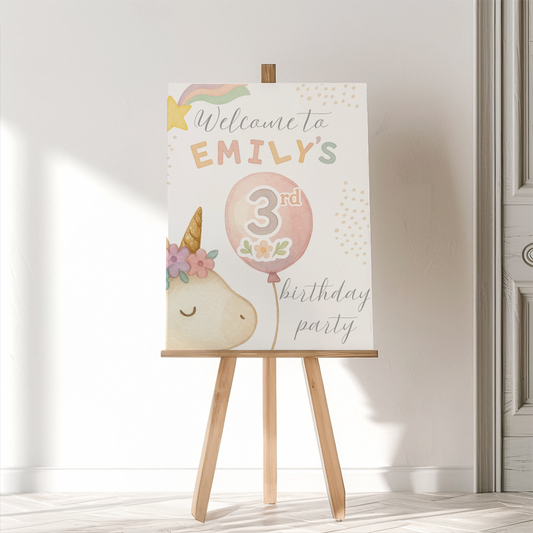 Birthday party sign on an easel with a unicorn design and text.