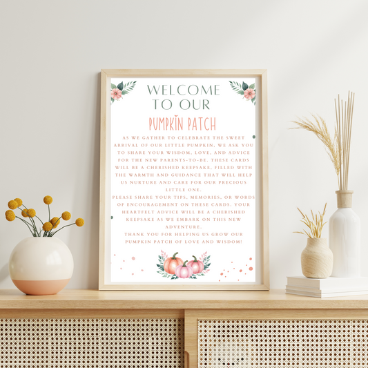Framed welcome sign for a pumpkin patch on a decorative shelf with plants.