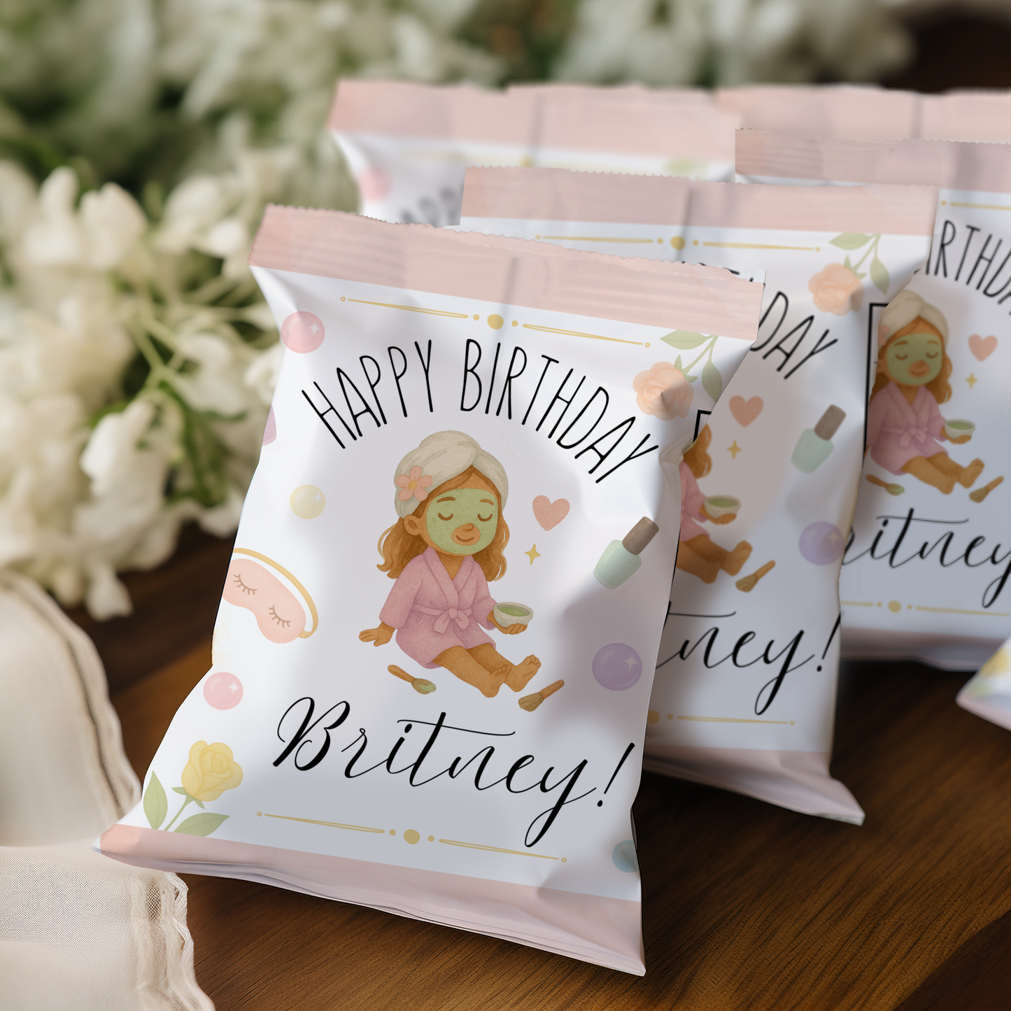 Personalized birthday snack bags with a girl in pajamas design on a wooden surface.