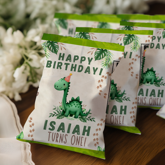 Birthday party favor bags with dinosaur design and personalized text on a wooden surface.