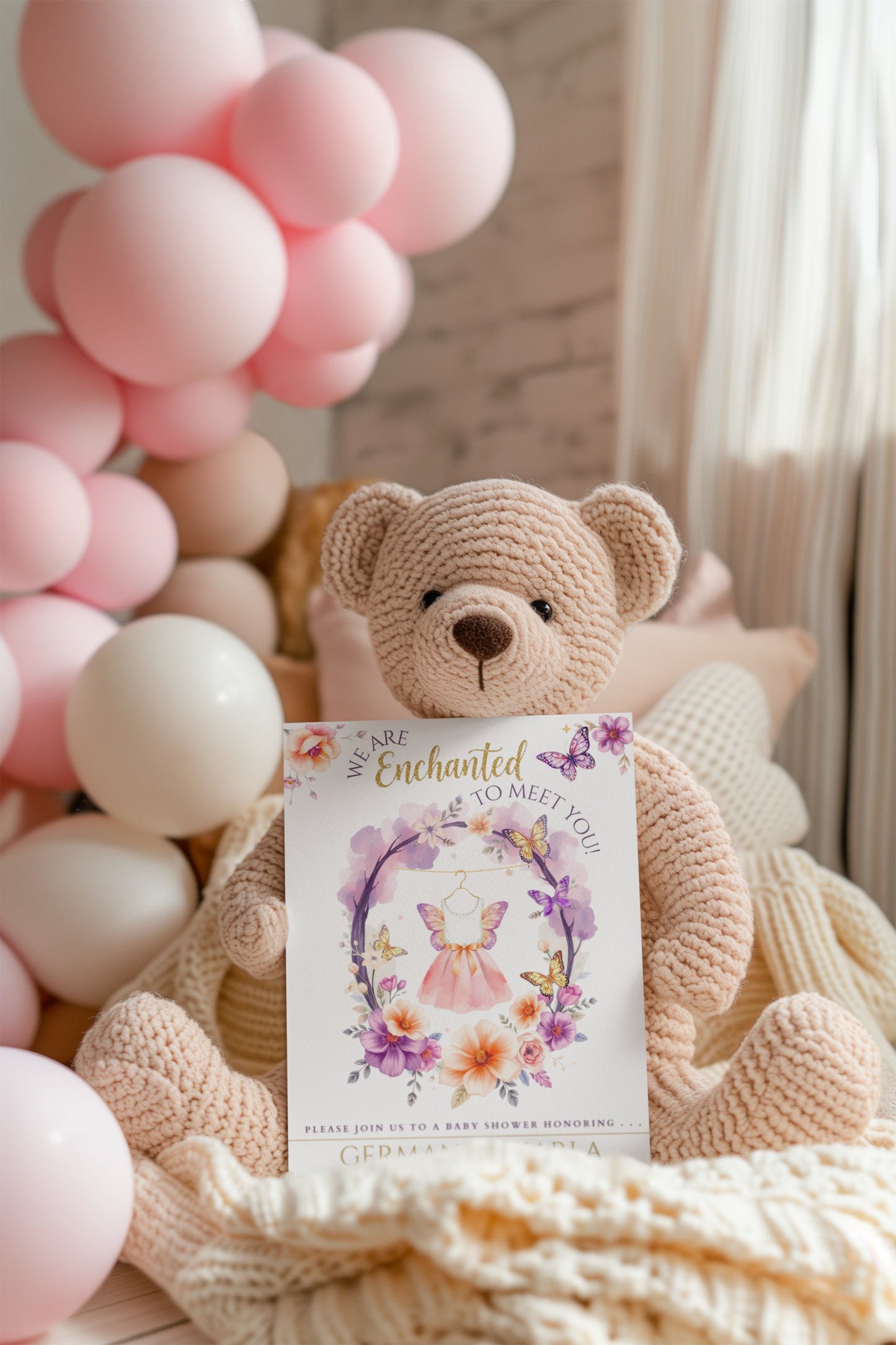 Teddy bear holding a card with balloons in the background