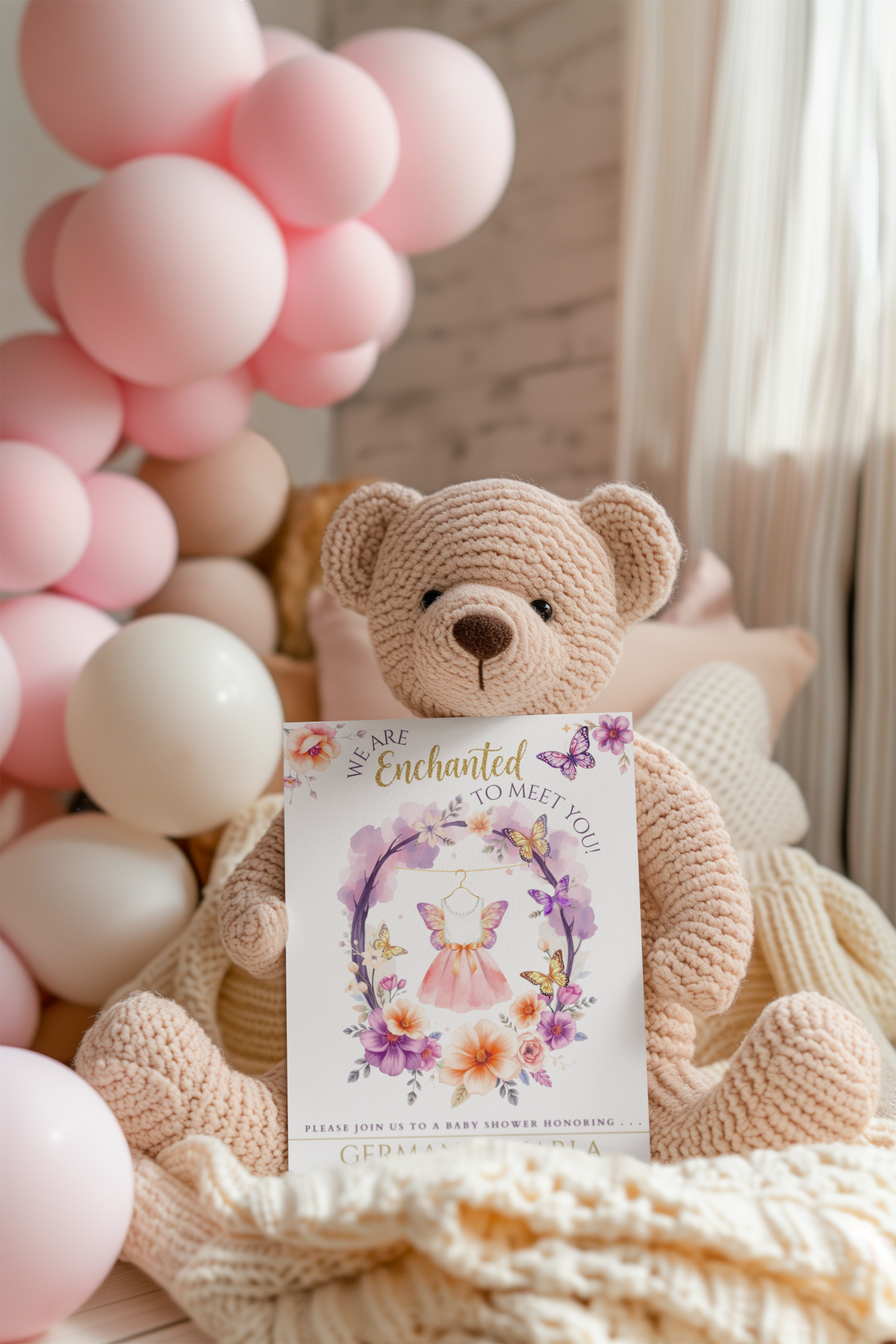 Teddy bear holding a card with balloons in the background