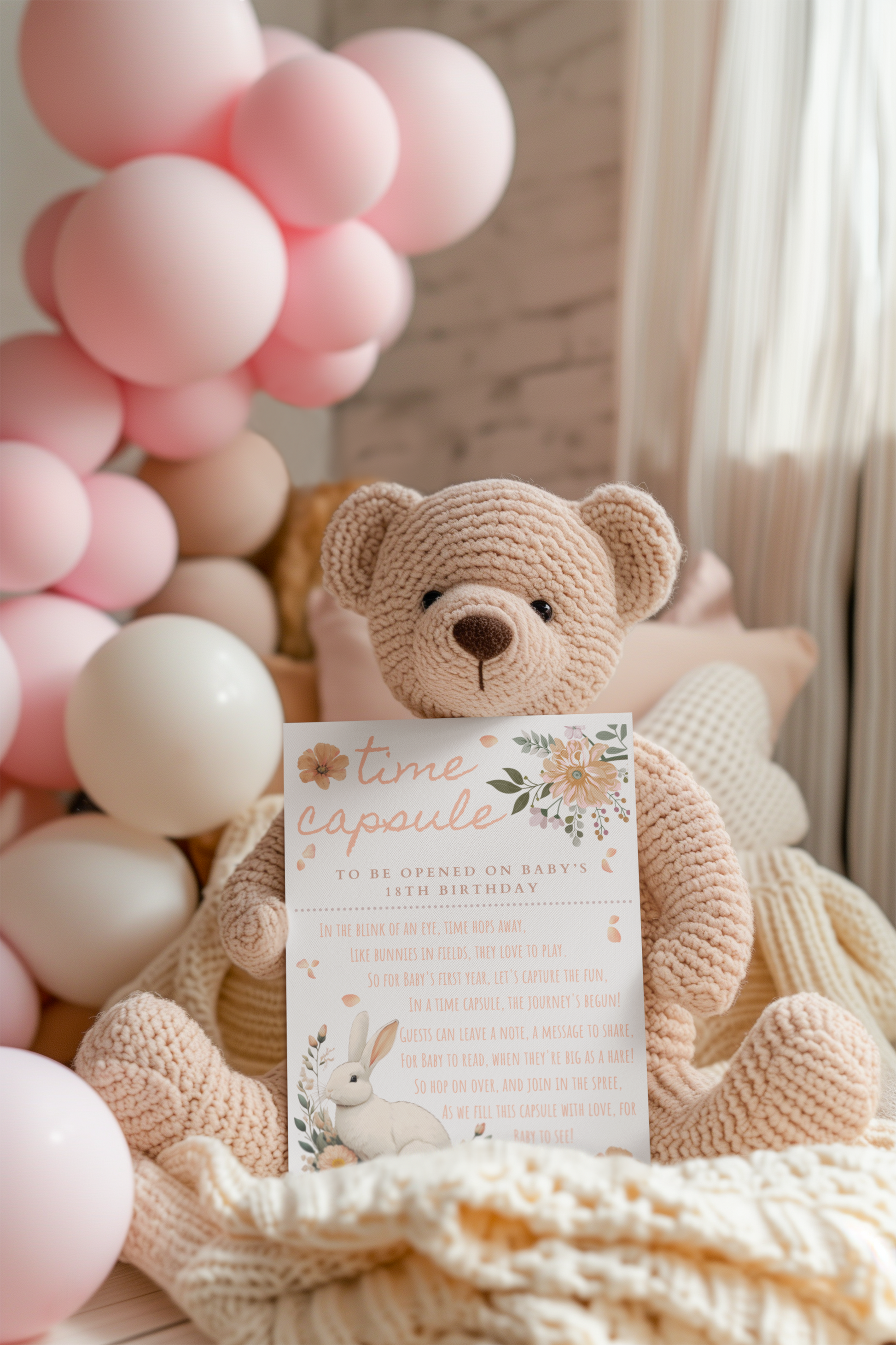 Knitted teddy bear with a time capsule and pink balloons in the background