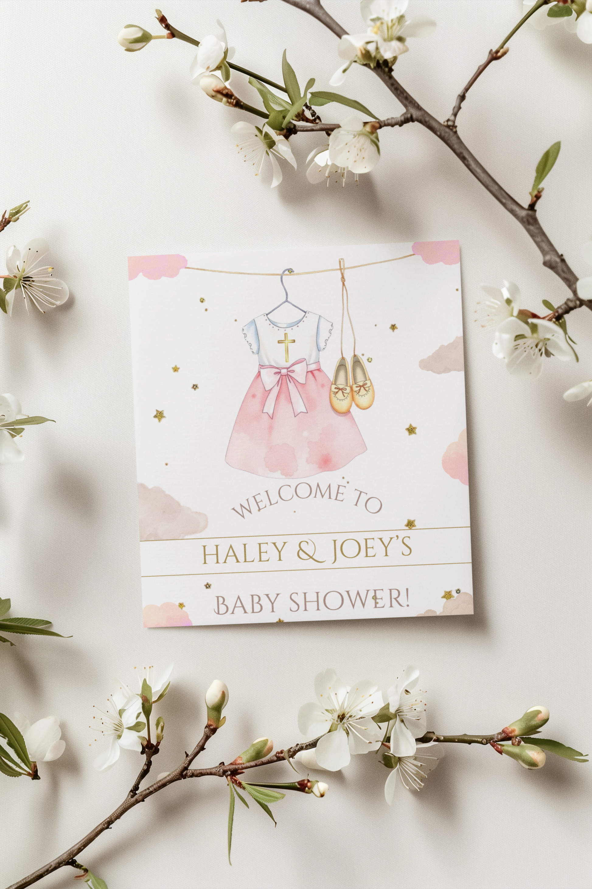 Baby shower invitation card with pink dress illustration on a white background with floral branches.