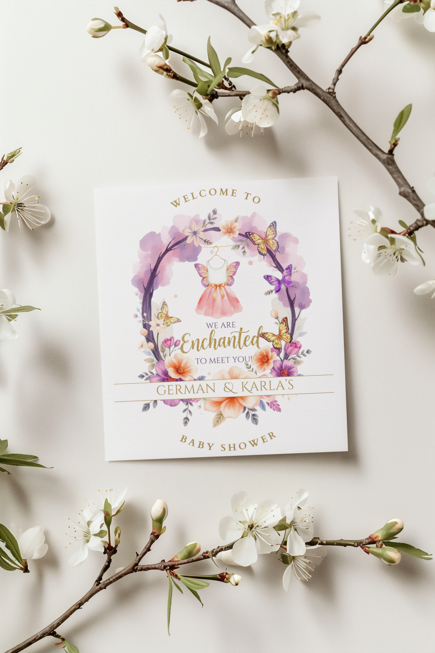 Baby shower welcome sign with floral design and butterfly on a white background with cherry blossom branches.