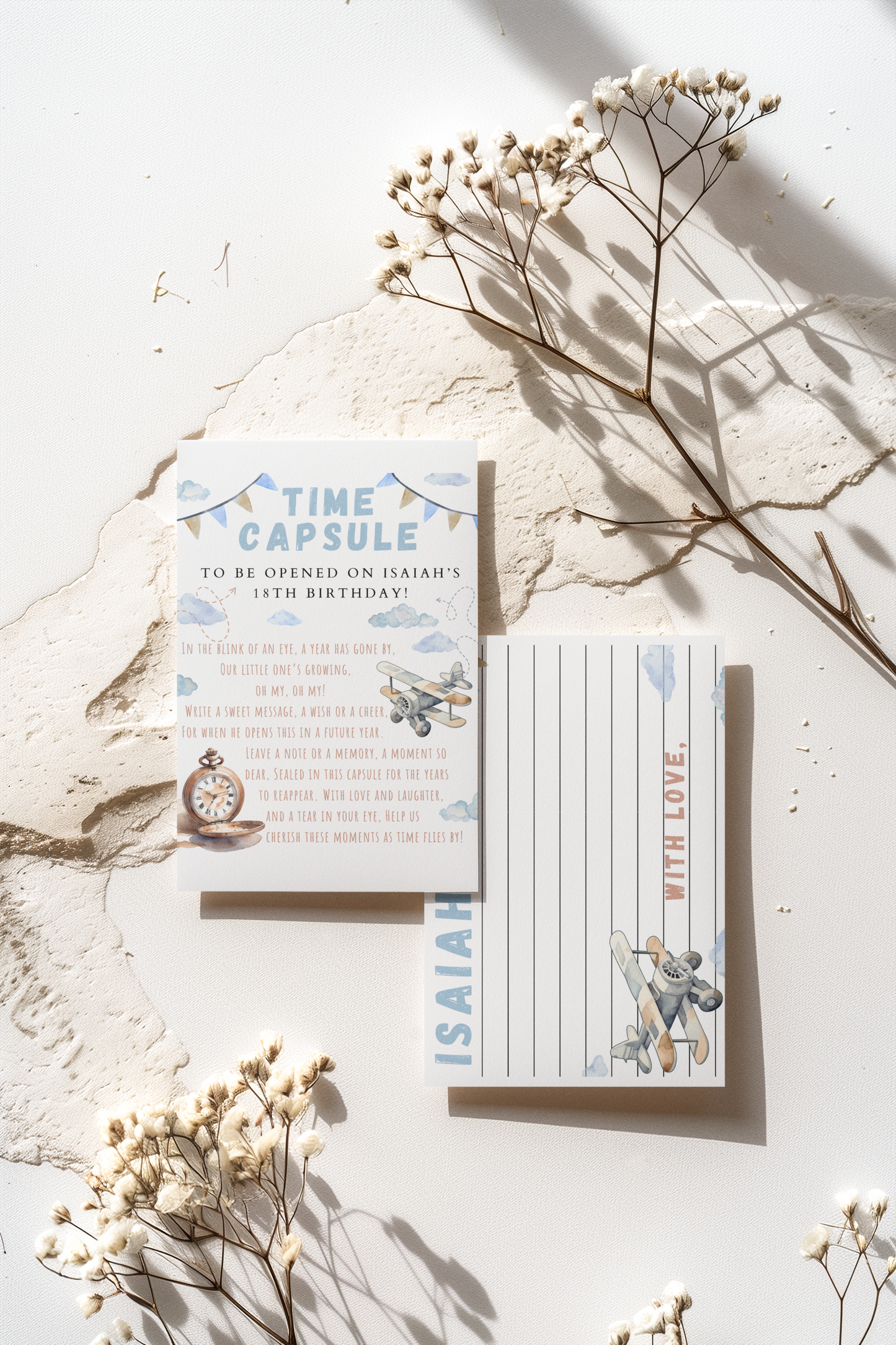 Time capsule with instructions and decorative elements on a light surface with dried flowers.
