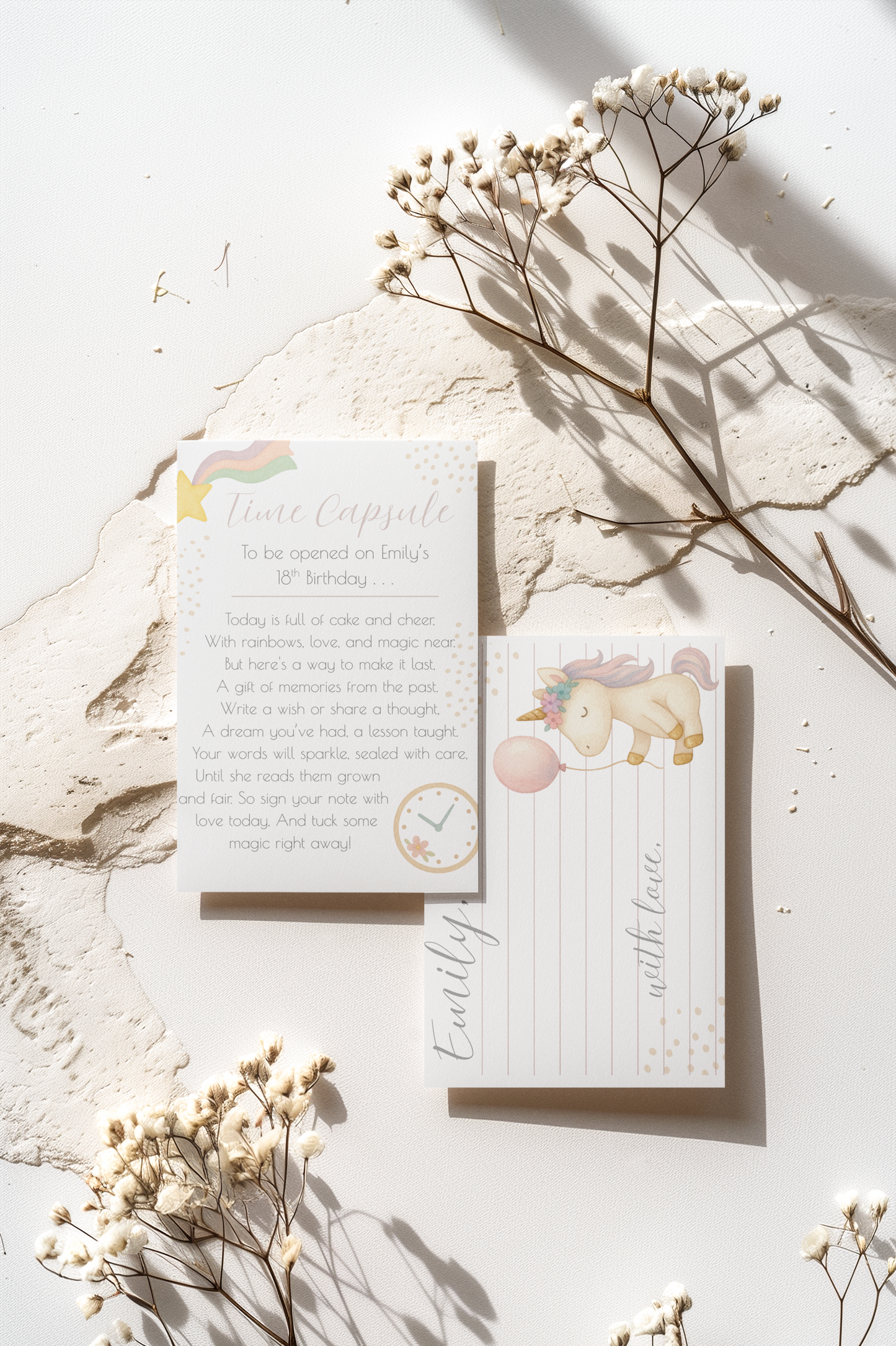 Stationery set with a card and envelope on a light surface with dried flowers.