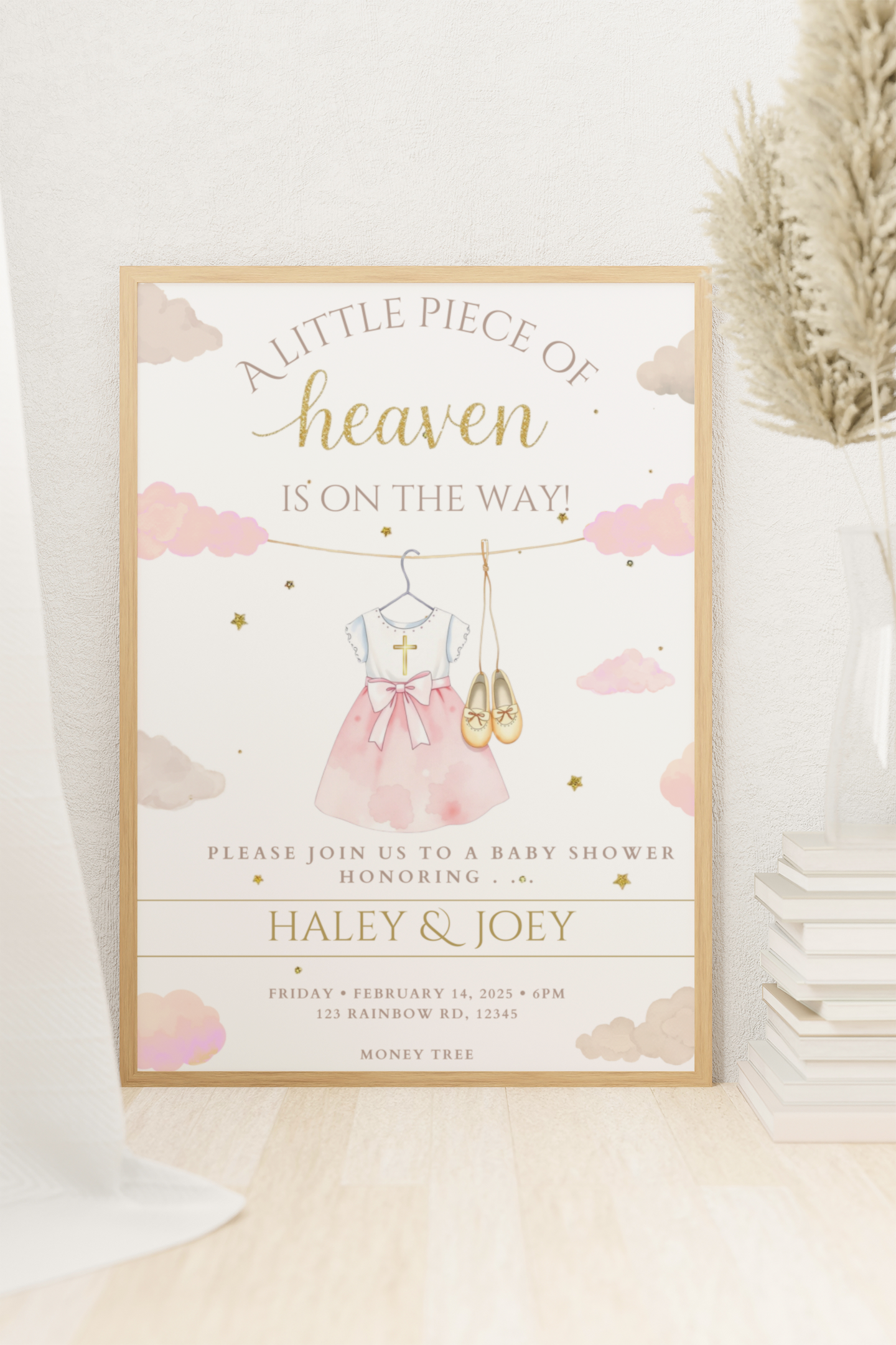 Baby shower invitation with pink dress and gold text on a light background