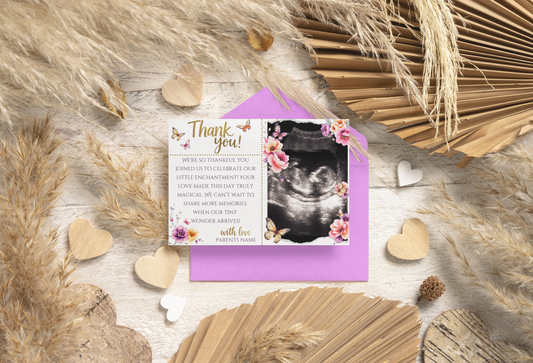 Greeting card with ultrasound photo and floral design on a textured surface with dried plants and hearts.