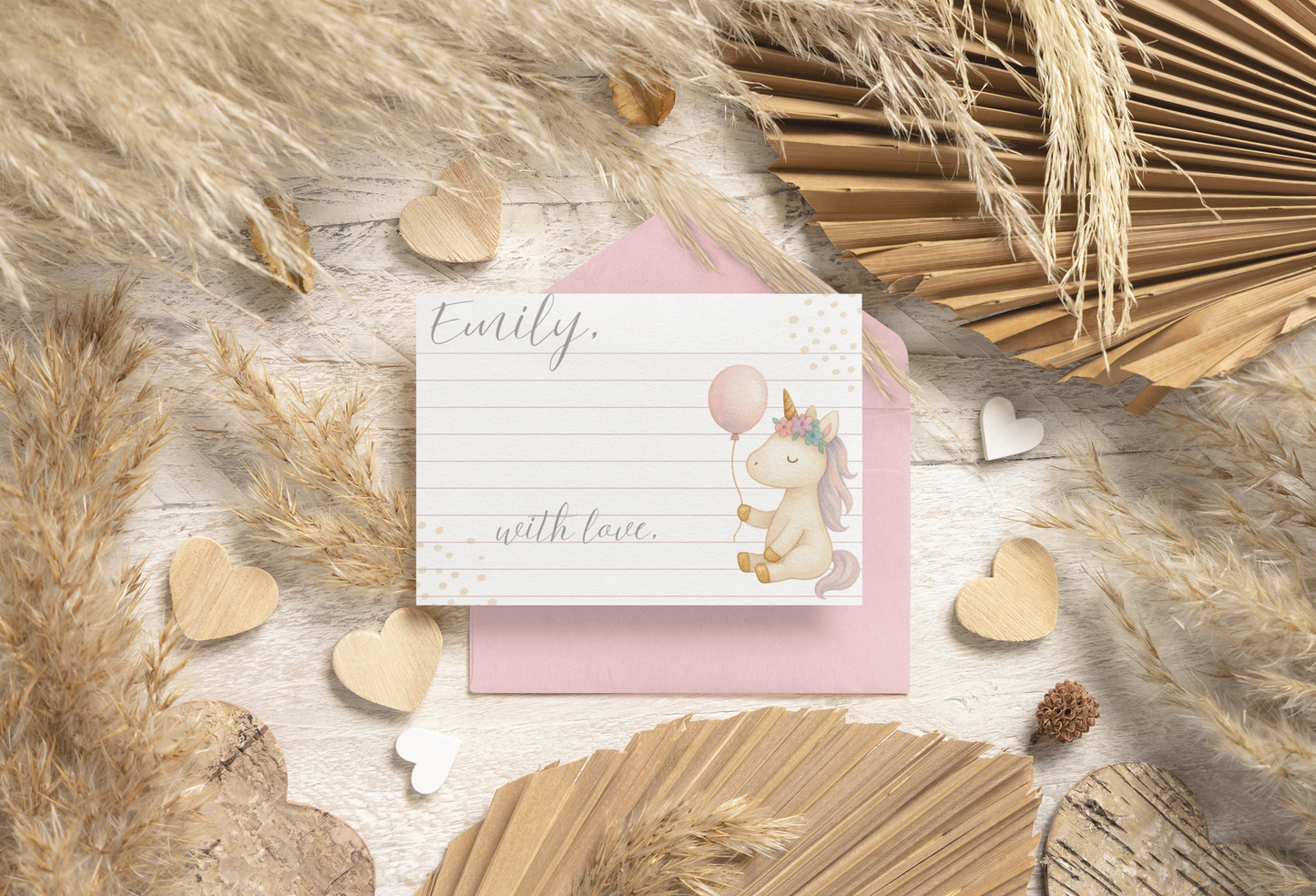 Greeting card with unicorn illustration on a wooden surface with decorative elements