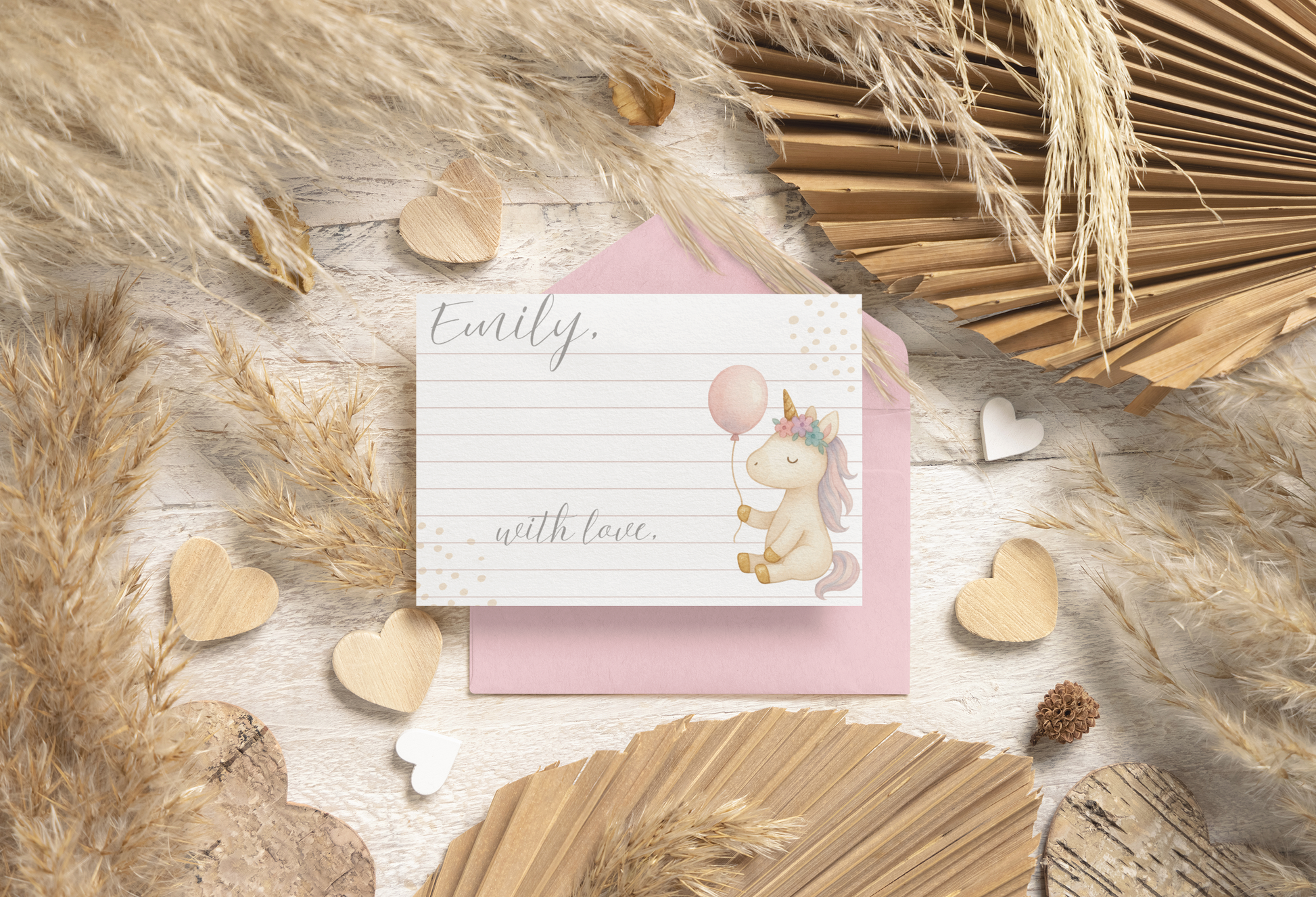 Greeting card with unicorn illustration on a wooden surface with decorative elements