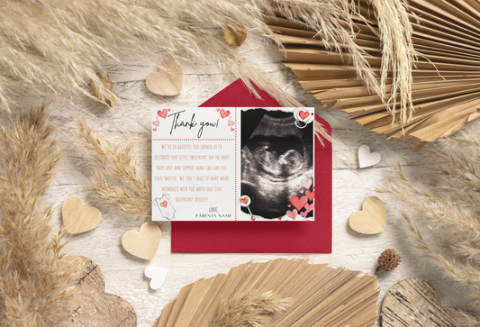 Thank you card with ultrasound photo surrounded by decorative elements on a wooden surface