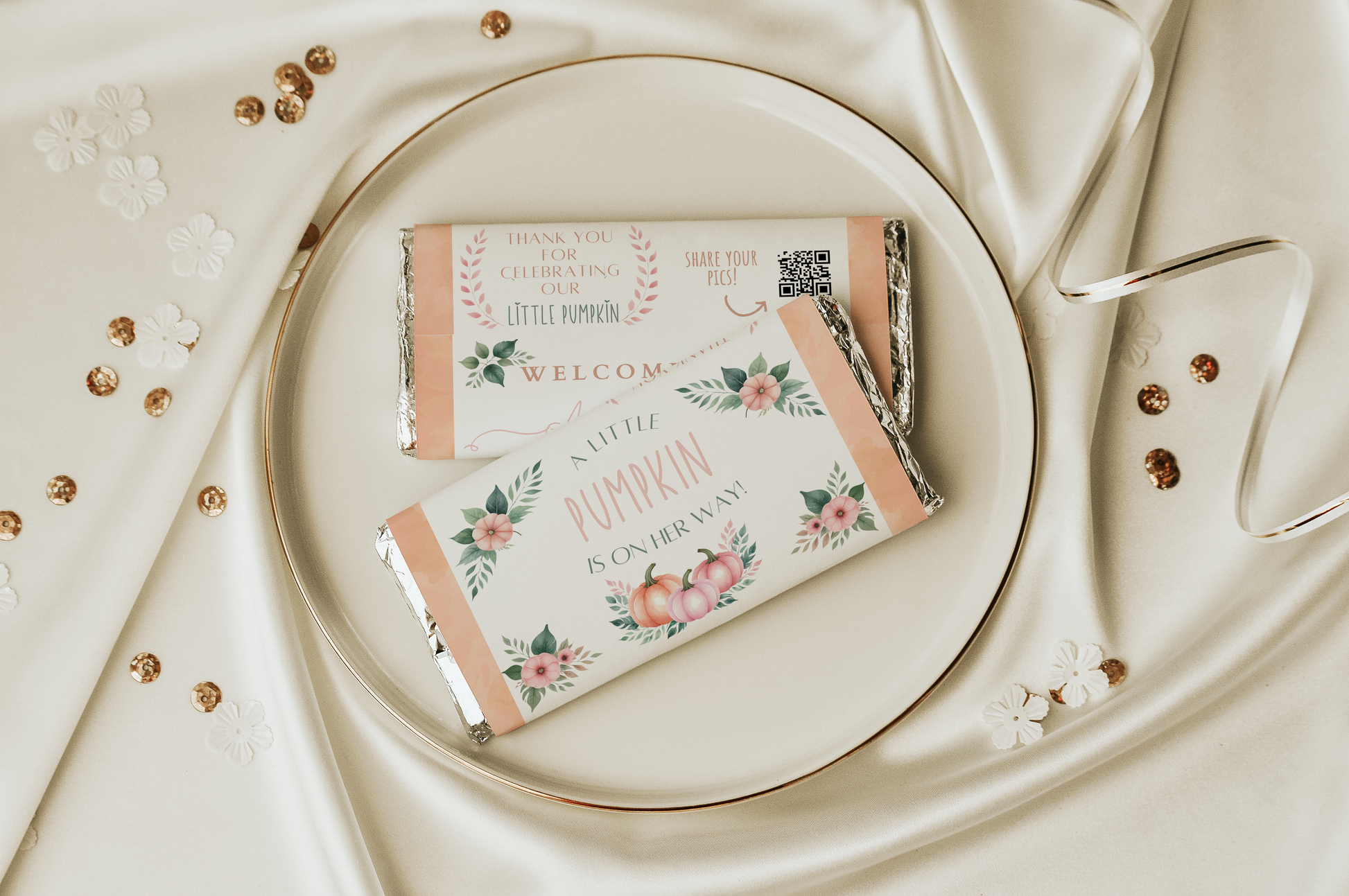 Decorative baby shower favor packages on a white plate with a decorative background