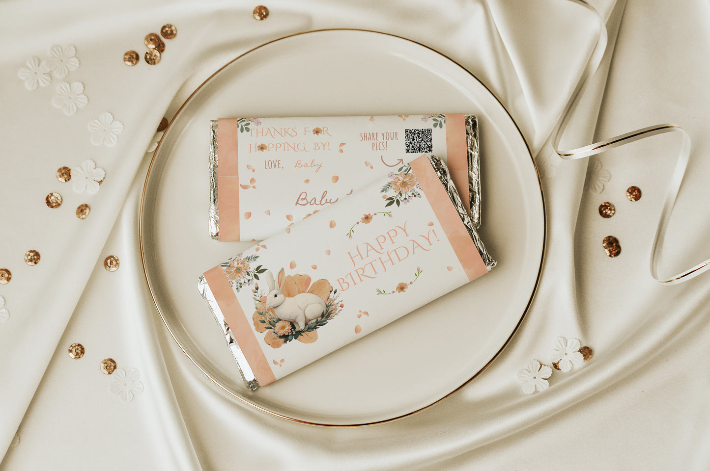 Two floral-themed chocolate bars on a white plate with a decorative background