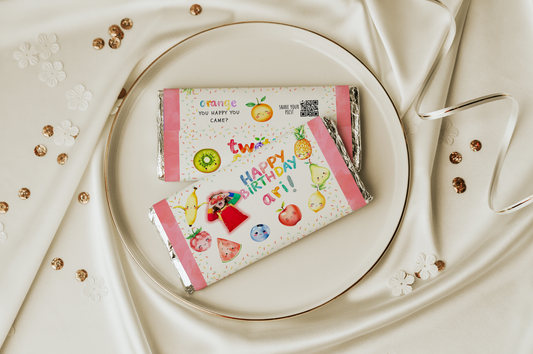 Two candy bars with colorful packaging on a white plate with a decorative background