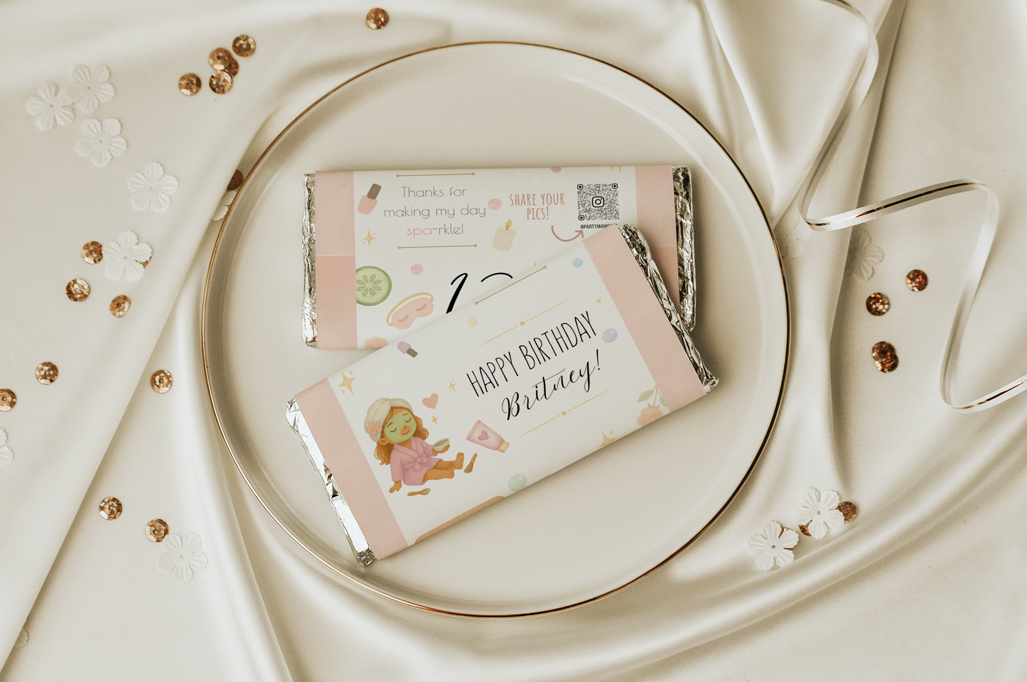 Two birthday-themed chocolate bars on a decorative plate with a white background