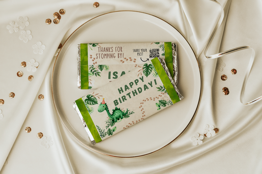 Two green chocolate bars with dinosaur illustrations on a white plate.