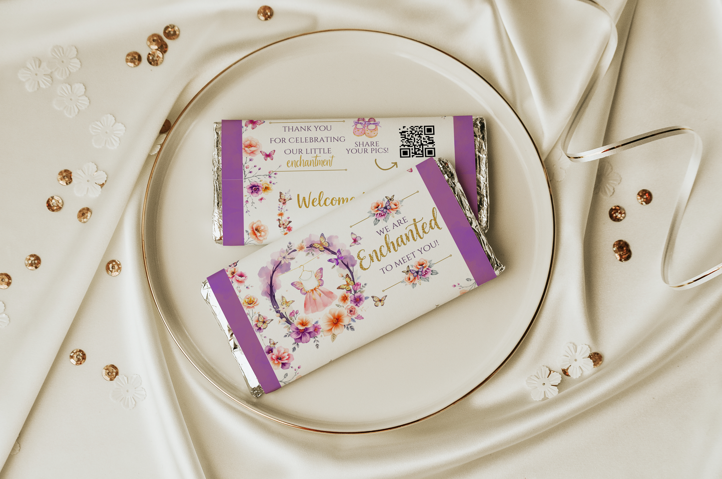 Decorative chocolate bars with floral designs and text on a white plate.