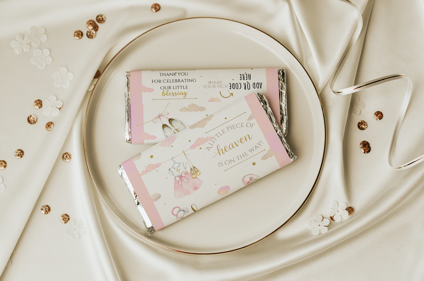 Chocolate bars with decorative packaging on a white plate with gold accents